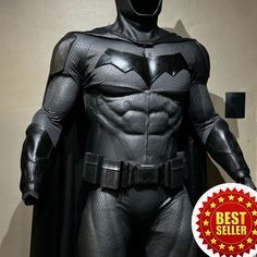 the batman statue is standing in front of a wall with best seller sticker on it