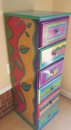 a multicolored dresser with drawers in a room