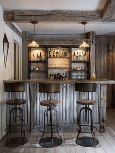 two stools sit at the bar in this rustic home