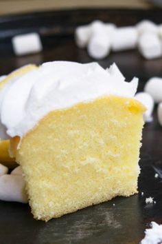 a piece of yellow cake with white frosting