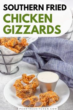 chicken gizzards on a plate with ranch dressing in the background and text overlay that reads southern fried chicken gizzands