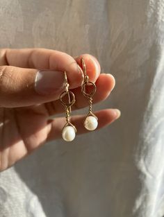 Real pearls and real gold.  These earrings are 1920's flapper inspired and they dangle when worn!  The hypo-allergenic and lightweight design of these makes for easy and stress-free wearing. The closure style is 'fishhook', but you can DM me if you would like a different closure style and I'll see what I can do. These earrings are made to order, so please allow me about a week's time to make them before I send them to you.  Thanks for viewing <3 ~ Father Figure Gold Wire Wrapped 14k Gold Filled Pearl Earrings, Elegant Adjustable Gold Earrings, Adjustable Gold Metal Pearl Earrings, Gold Pearl Adjustable Earrings, Adjustable Gold Pearl Earrings With Ear Wire, Elegant Adjustable Hypoallergenic Hoop Earrings, Pearl Dangle Earrings With French Hook, Pearl Dangle Earrings With Lever Back, Elegant Brass Hoop Earrings With Pearl Drop