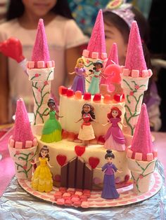 there is a cake decorated with princesses on it