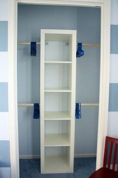 an empty closet with blue and white striped walls