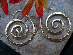 "These swirl hoops are hand pound, shaped and polished. Hand made ear wires are sterling silver. Great for every day. The texture and hand forged quality catches the light and give these simple earrings dimension. High quality craftsmanship, but light weight. Available in solid copper, bronze or sterling silver. Ancient spiral meaning: Evolution, Life, Consciousness, Creation Size: Medium 1 7/8\" H x 1 5/8 \" W Finish: Satin finish is a matte brushed finish. High shine is polished to a brilliant Spiral Brass Hoop Earrings With Ear Wire, Spiral Brass Jewelry, Unique Hammered Spiral Jewelry, Hammered Spiral Sterling Silver Jewelry, Hammered Sterling Silver Spiral Jewelry, Unique Spiral Nickel-free Hoop Earrings, Unique Nickel-free Spiral Hoop Earrings, Hammered Brass Spiral Jewelry, Unique Hand Forged Spiral Earrings