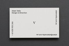 a white business card sitting on top of a table