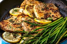 chicken, asparagus and lemons in a skillet