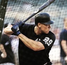 a man holding a baseball bat on top of a field