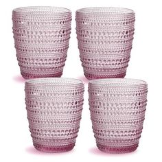 four pink glass cups sitting next to each other