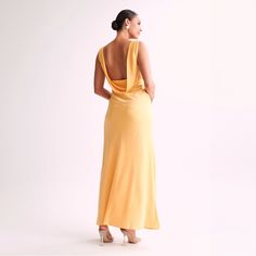 a woman in a yellow dress looking back