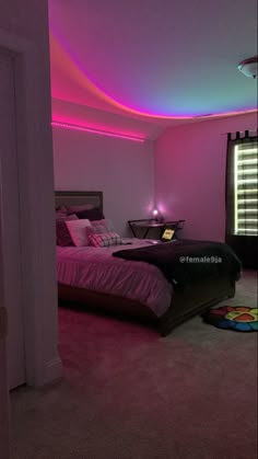 a bed room with a neatly made bed and purple lights on the ceiling above it