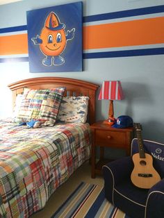 a bed room with a neatly made bed and a guitar