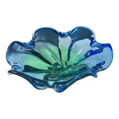 a blue glass bowl sitting on top of a white table