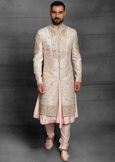 Custom Made Designer Off White Designer Groom Sherwani
Designer custom made ivory fully embroidered sherwani with chudidar in UK . The latest heavy silk embroidered sherwani is best choice for groom . It is suited for Indian and Pakistani wedding wear . 
One of the standout features of this sherwani is the intricate embroidery adorning its surface. Our skilled artisans have meticulously handcrafted every detail, using fine threads and intricate patterns that showcase traditional Indian craftsmanship at its best. The embroidery showcases a harmonious blend of motifs, ranging from floral designs to intricate geometric patterns, creating a visually stunning ensemble that captures attention and admiration . Please note there can be slightly difference between the image and the product due to