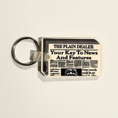 Discover the charm of nostalgia with our Vintage Ohio Plain Dealer Newspaper Keychain. This unique 80s rubber accessory is not just a key ring; it’s a piece of history that adds a delightful touch to your collection. Featuring a classic white color, this keychain is perfect for those who appreciate vintage collectibles and want to showcase their love for the past.Vintage Ohio Plain Dealer Keychain - Unique 80s Rubber Accessory Material: Durable rubber that stands the test of time Size: Compact 1 Vintage Keychain, Unique Keychain, Nostalgic Design, Holiday Puzzle, Character Making, Unique Keychains, Vintage Trucker Hats, Tie Shop, Functional Accessories