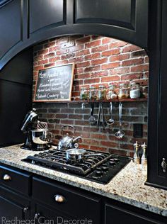 a brick wall in a kitchen with pots and pans on the stove