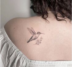 a woman with a hummingbird tattoo on her back