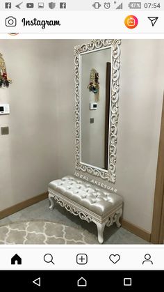 a white bench sitting in front of a mirror