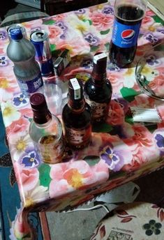 the table is covered with various bottles of alcohol