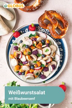 a white plate topped with vegetables and pretzels