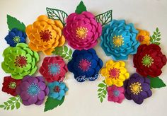 colorful paper flowers arranged on a white surface