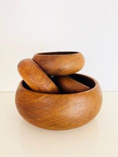 three wooden bowls stacked on top of each other