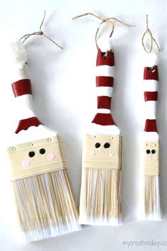 three toothbrushes decorated like santa's hats