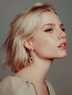 a woman with blonde hair wearing earrings