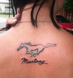 a woman's back with a horse tattoo on her neck and the word mustang written in cursive font