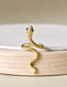 Intertwine yourself in luxury with our Snake Ring. The delicate snake design is expertly crafted with 14k gold plating and rhodium plating, exuding elegance and craftsmanship. Make a statement with this unique and timeless piece that alludes to the exotic and alluring world of the snake. Made in Colombia Yellow Gold Snake Ring For Wedding, Elegant Snake Ring For Anniversary, Elegant Snake Shaped Ring For Anniversary, Elegant Yellow Gold Snake Ring, Gold Fine Jewelry Snake-shaped Ring, Adjustable Snake Ring In Yellow Gold, Elegant Gold Snake Ring, Luxury Yellow Gold Snake Shaped Ring, Formal Yellow Gold Snake Ring