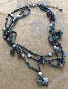 "Featuring this lovely turquoise paua shell and wooden beaded multi-strand necklace. It is adjustable and measures from 16\" to 18\" and has gold tone accents. The necklace is in very good vintage condition and has a silver tone extender." Adjustable Multi-strand Turquoise Necklace With Colorful Beads, Handmade Multi-strand Turquoise Necklace For Beach, Artisan Multi-strand Beaded Turquoise Necklace, Multi-strand Turquoise Gemstone Beads Necklace, Multi-strand Mother Of Pearl Beaded Necklaces, Turquoise Multi-strand Beaded Necklace, Beaded Multi-strand Mother Of Pearl Jewelry, Multi-strand Beaded Mother Of Pearl Jewelry, Multi-strand Beaded Mother Of Pearl Necklace