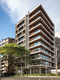 an apartment building with many balconies on the top floor, and lots of windows