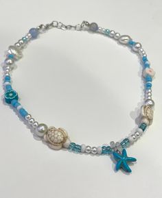 this necklace is so cute with blue accents and white details! cute charms paired with pearls and seed beads with a starfish in the middle! Sea Necklace, Canoga Park, Brown Mushroom, White Details, Sea Theme, Heart Sign, Cute Charms, Blue Accents, How To Make Beads