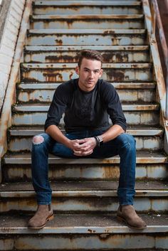 a man sitting on top of some stairs