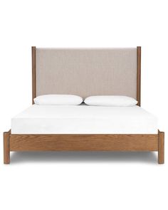 a bed with two pillows on top of it and a headboard in the middle