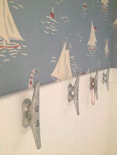 there are many sailboats painted on the wall