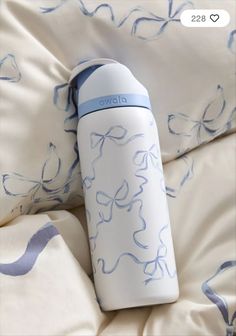 a white and blue water bottle sitting on top of a bed