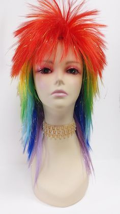 Rock out with this awesome costume wig!  Color: Rainbow and Golden Tinsel (Rainbow/TSL) Style: 15 inches, Long Layered, Spikey Circumference: Default at 21" with adjustable cap (max 22") All sales are final. Please read all store policies before purchasing. Rainbow Mullet, Wigs Rainbow, Clown Drag, Unicorn Wig, Clown Wig, Mullet Wig, Outfit Planning, Edgar Allen, Scary Funny