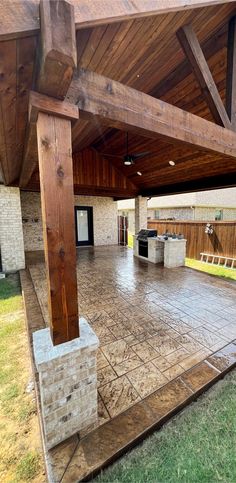 a covered patio with an oven and grill