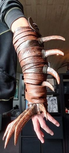 a person is holding out their arm made from leather