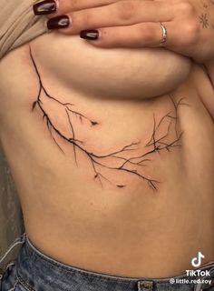 a woman's stomach with branches on it