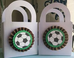 two paper bags with soccer decorations on them