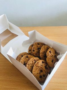 a box filled with cookies sitting on top of a wooden table