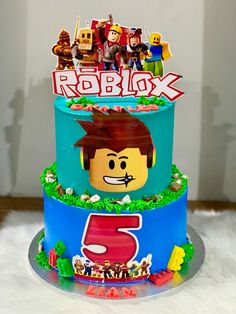 a lego movie themed birthday cake on a white furnishing area with the number 5