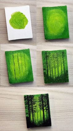 four square coasters with green trees painted on them