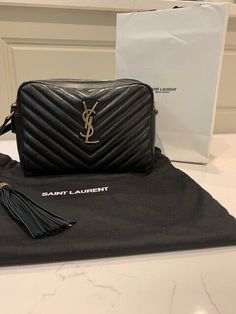 •Pre-owned and blemish free•Purchased as a gift for my wife•Not “her” preferred style•Limited Use by her•Saint Laurent "Lou" crossbody bag in black quilted leather •Features YSL logo lettering in brass/gold color•Shoulder strap•Leather Tassle•Zip top closure •Interior, one slip pocket •Approx. 6.2"H x 9.0"W x 2.3"D•Made in Italy Saint Laurent Lou Crossbody Bag, Ysl Lou Camera Bag Black, Saint Laurent Black Bag, Ysl Black And Gold Bag, Black Ysl Bag Quilted, Saint Laurent Handbags, Boho Purses, Black Quilt, Gifts For My Wife