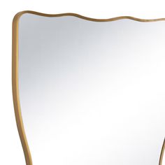 a white and gold framed mirror on a wall