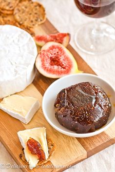 cheese, crackers and figs on a cutting board