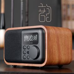 a wooden clock radio sitting on top of a table