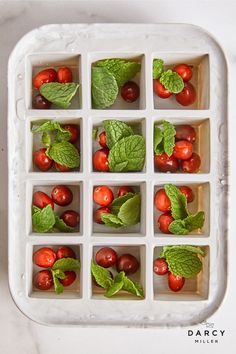 tomatoes and mint leaves in an ice tray